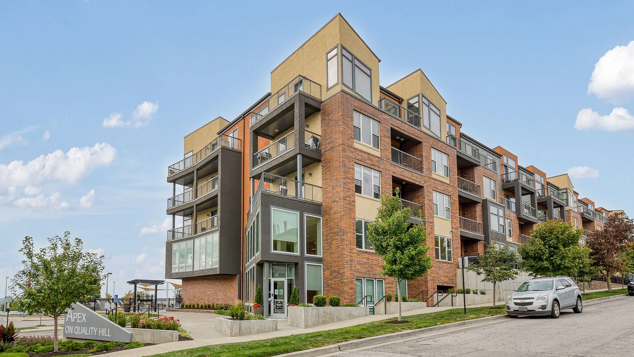 Modern apartment complex with stylish brick facade and spacious balconies at Apex on Quality Hill.
