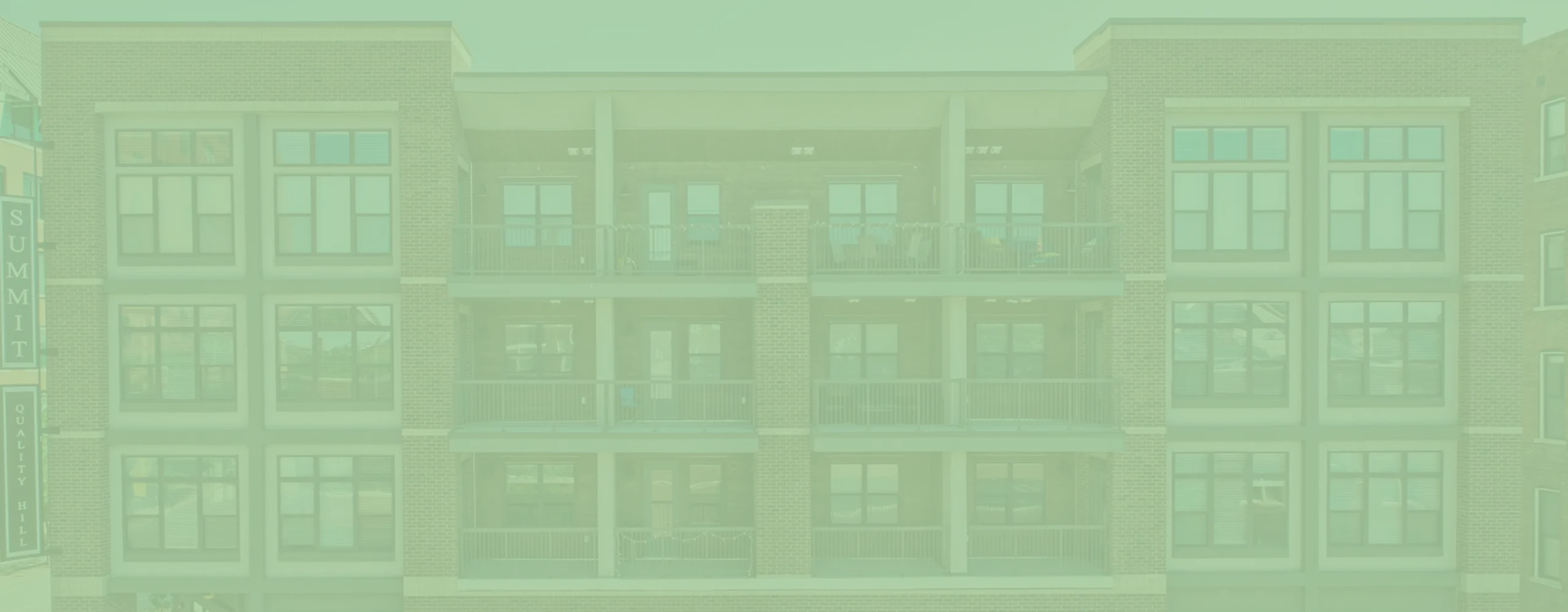 Charming brick apartment building with spacious balconies showcasing modern urban living.