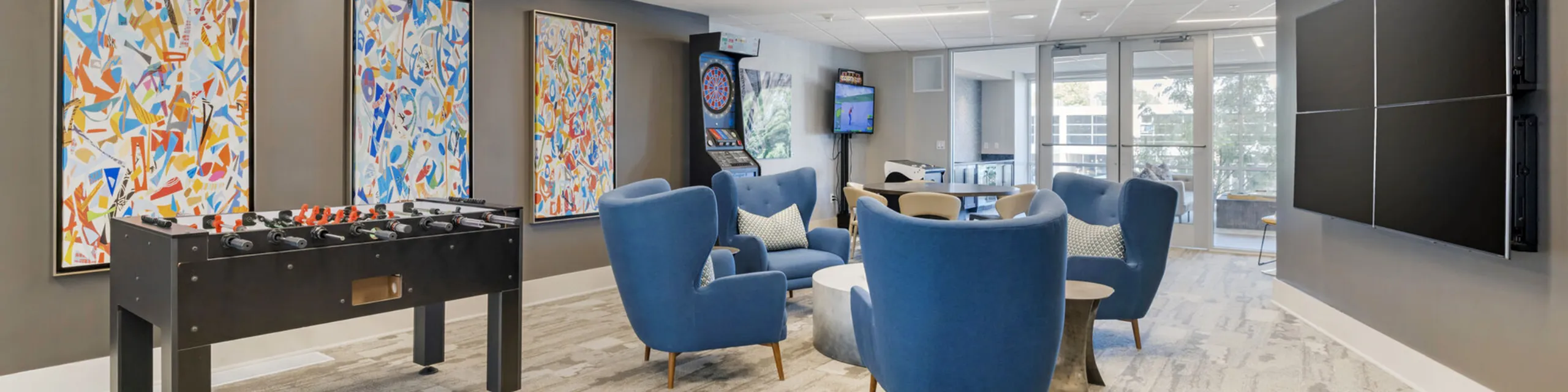 Bright and inviting living room with plush light blue sectional sofa, modern decor, and large windows providing ample natural light.