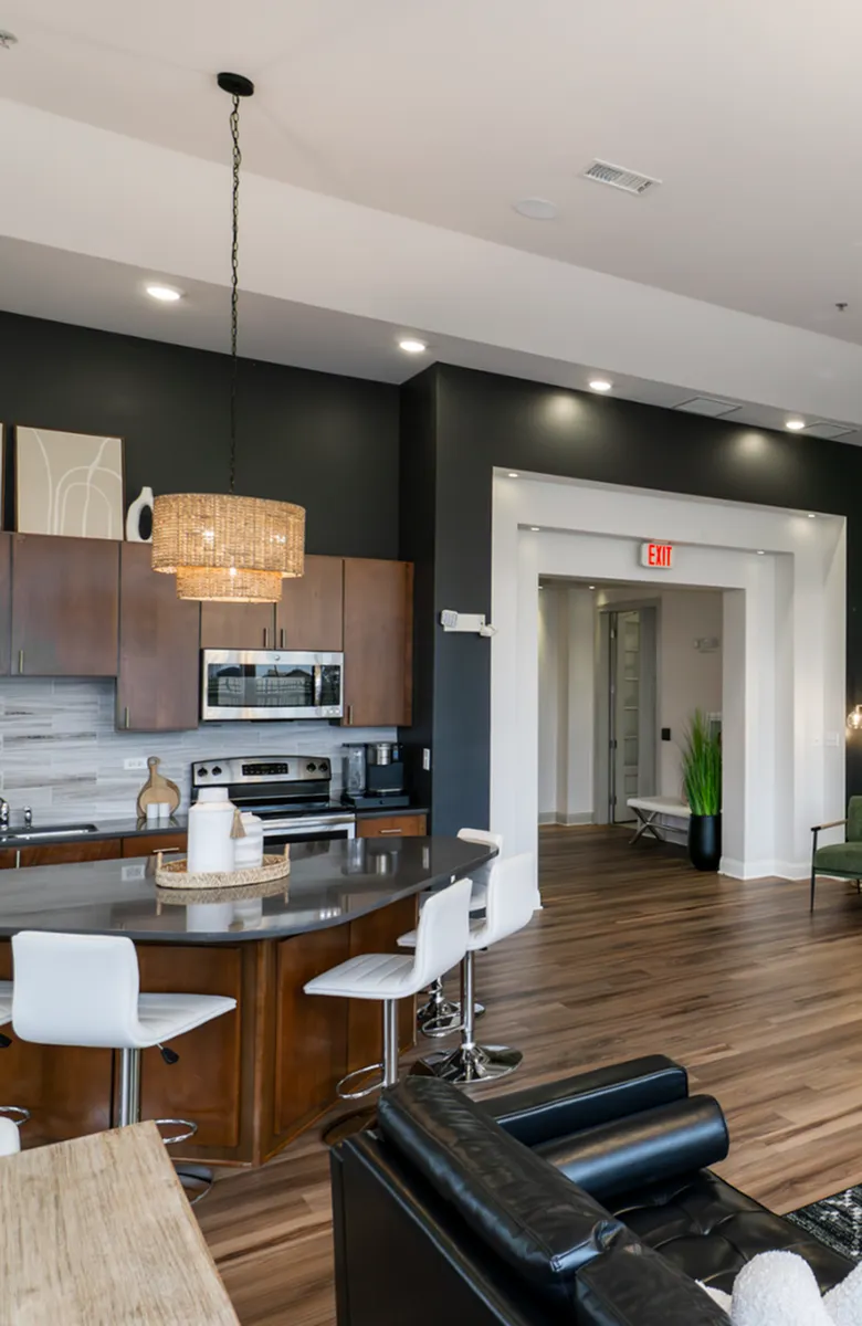 Modern kitchen with sleek stainless steel appliances, rich dark cabinetry, and elegant granite countertops.