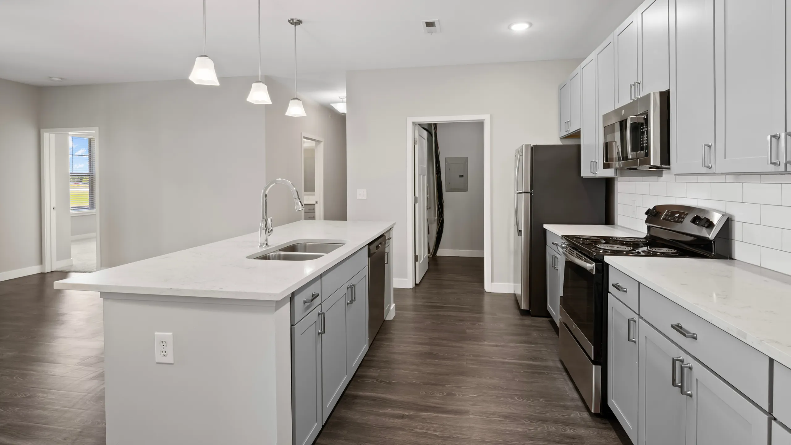 Modern kitchen with sleek stainless steel appliances, elegant white cabinetry, and a stylish breakfast bar with seating.