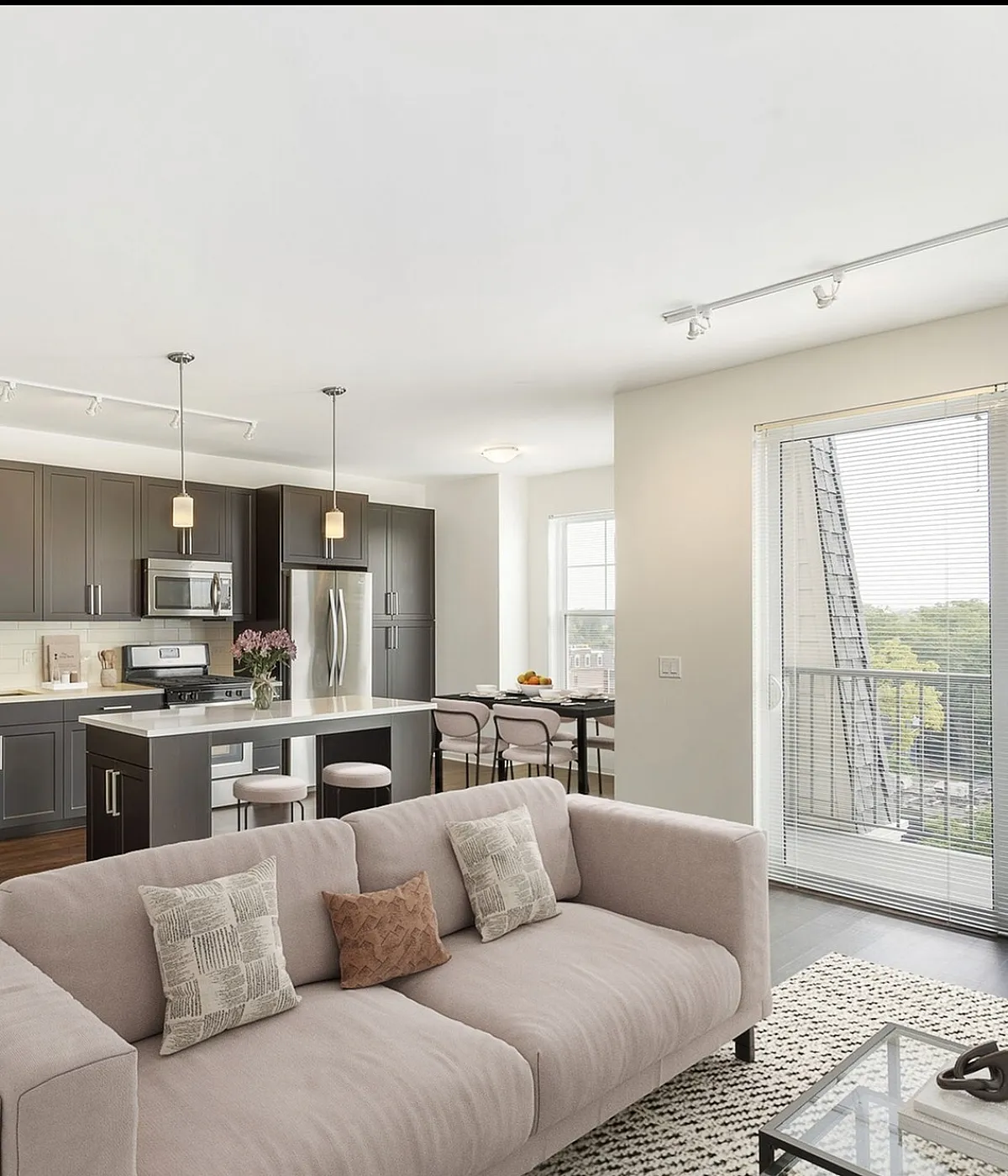 Charming brick apartment building with classic architectural details and lush landscaping, ideal for modern living.