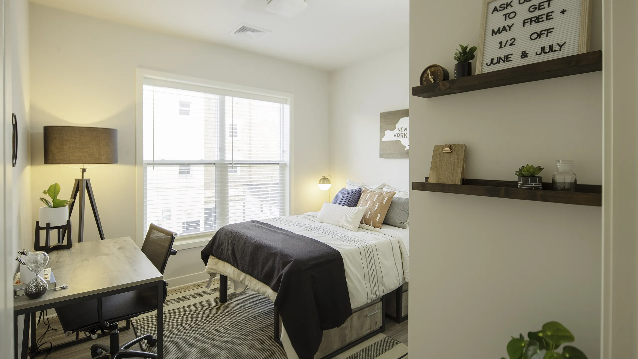 Inviting and cozy bedroom with chic decor, ample natural light, and a modern workspace, perfect for comfort and productivity.