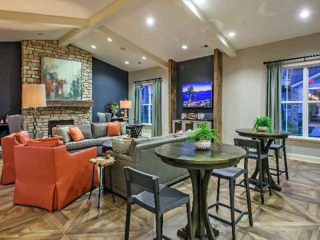Clubhouse interior with seating and a fireplace.
