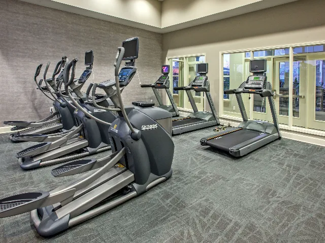 Fitness center featuring treadmills and elliptical machines.
