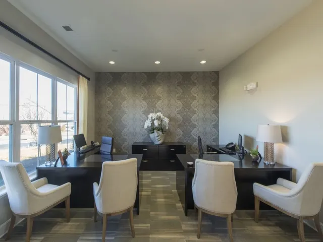 Leasing center interior, facing two desks, one to either side.