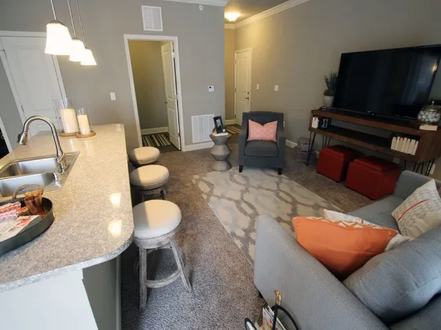 Carpeted living room and kitchen breakfast bar.