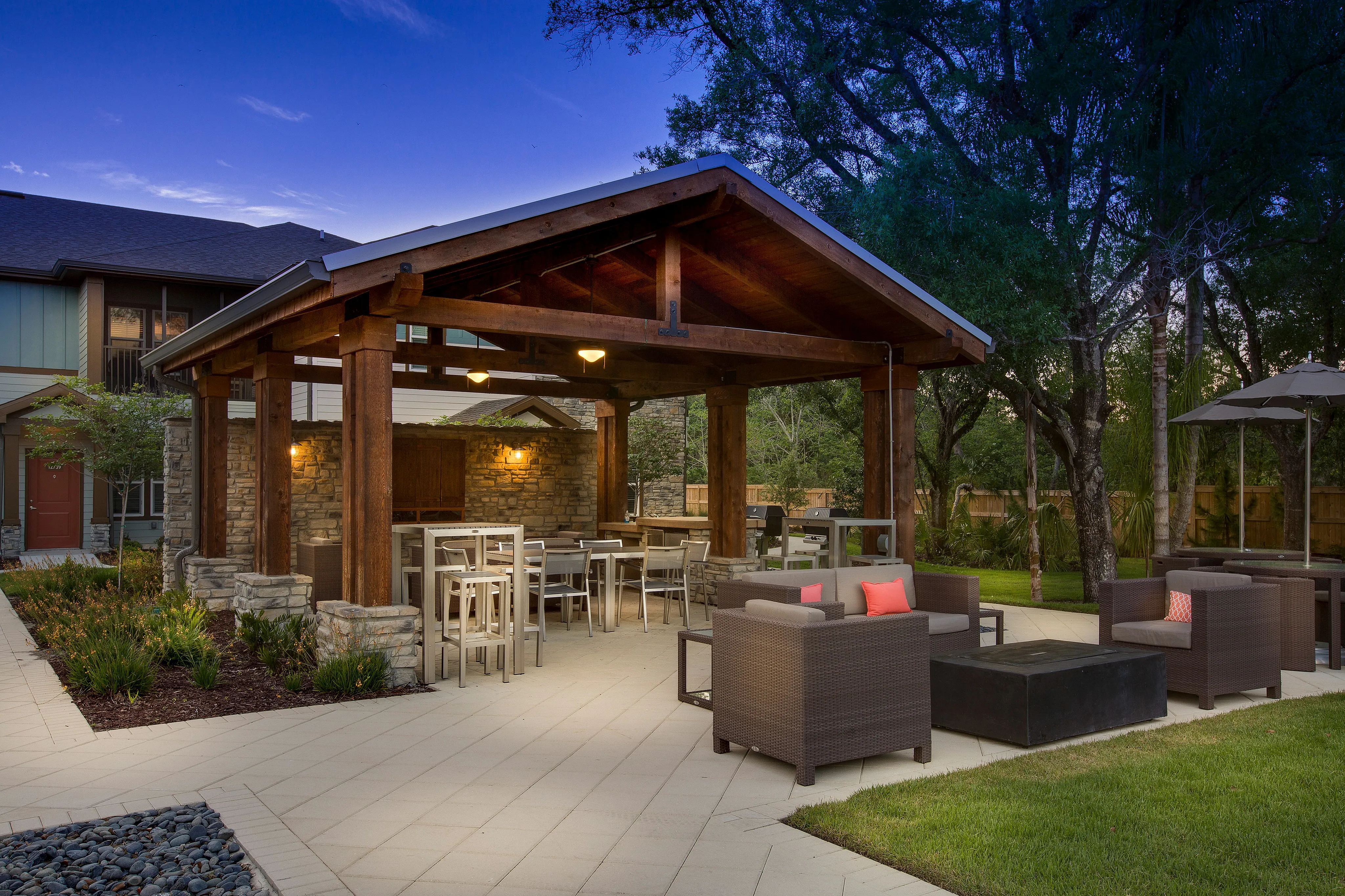 Charming outdoor patio with stylish wooden pergola, cozy seating area, and lush greenery for serene relaxation.