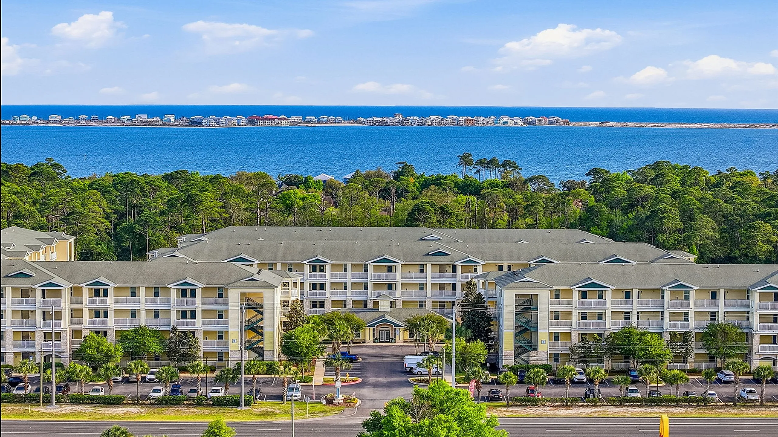 Charming coastal apartment complex with picturesque ocean views, surrounded by lush greenery and offering convenient access to beachfront living.