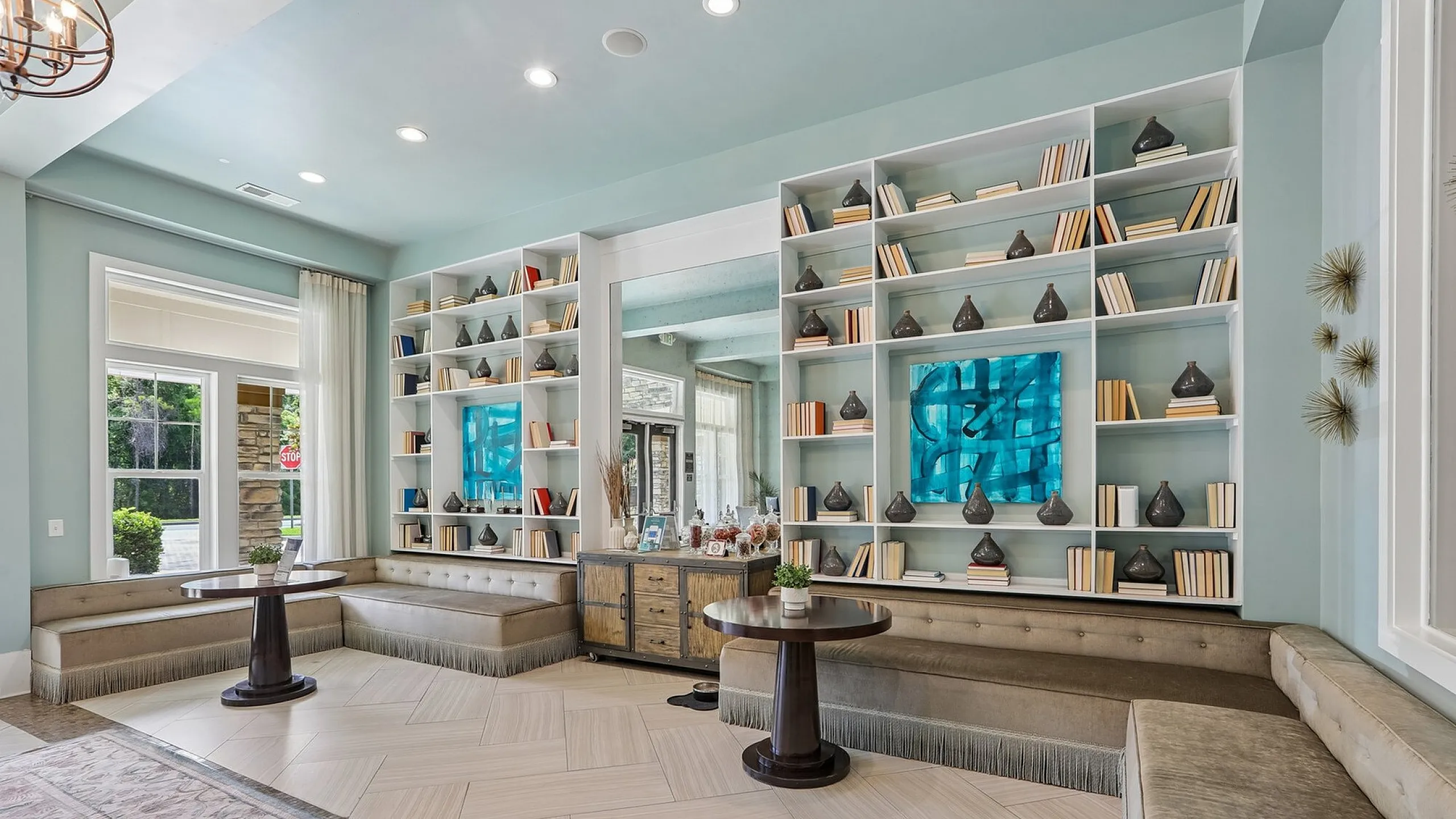 Chic and inviting library lounge with elegant built-in bookshelves, cozy seating, and modern decor, perfect for relaxation and reading.