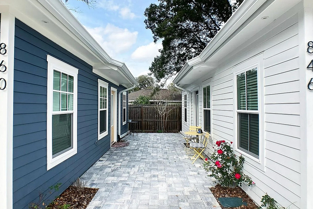 Paver courtyard walkway between student townhomes with patio seating near UF Gainesville