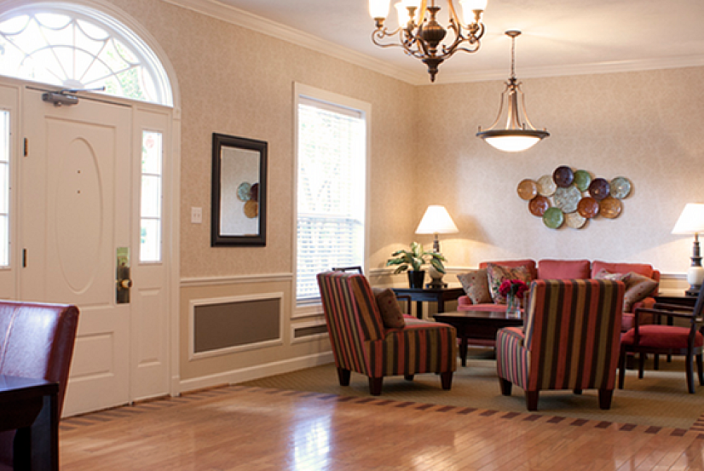 Inviting living room with elegant lighting, cozy seating, and stylish wall decor, perfect for relaxation and entertaining.