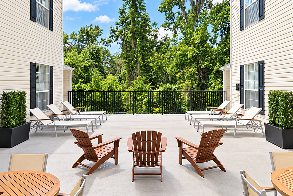 Charming outdoor patio featuring stylish lounge chairs and scenic views of lush greenery, perfect for relaxation and outdoor enjoyment.