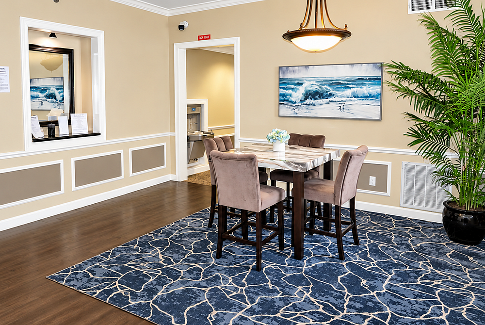 Elegant dining space with chic chandelier, ocean-themed artwork, and lush plant, offering a welcoming ambiance.