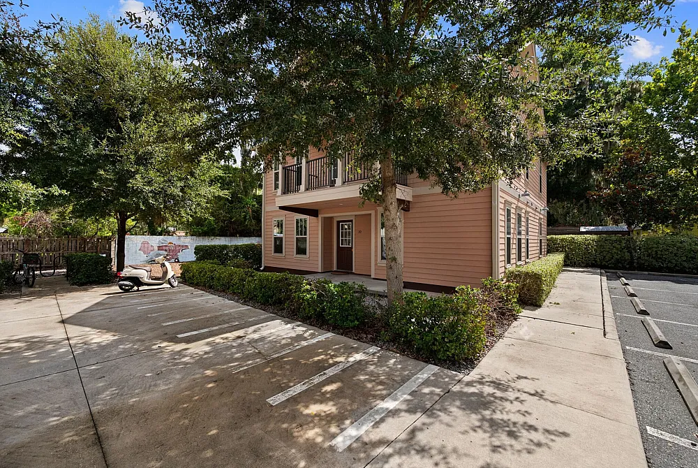 Charming two-story house surrounded by lush greenery and featuring a private driveway, perfect for tranquil living.