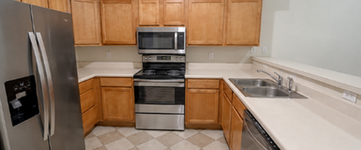 Modern kitchen with tile and stainless steel appliances.