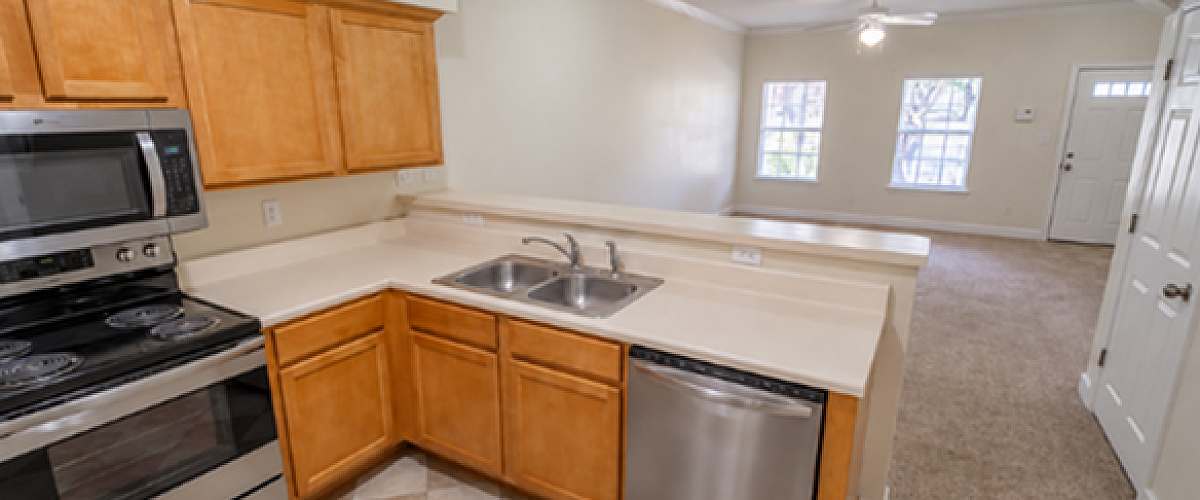 Modern kitchen with tile and stainless steel appliances.