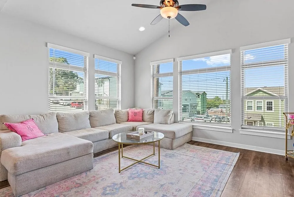 Beautiful open-concept living area with a cozy sectional sofa bathed in natural light.