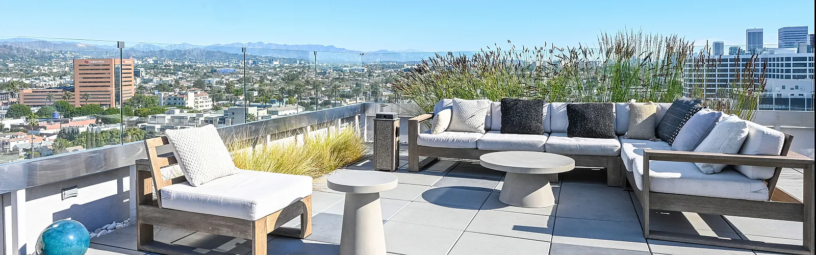 Luxurious rooftop terrace with modern outdoor furniture and panoramic city views.