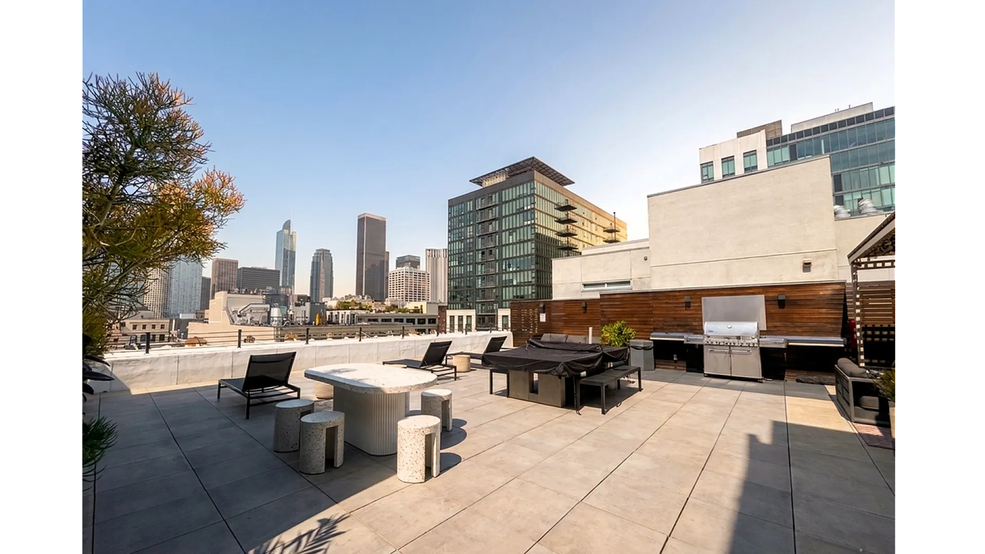 Luxurious rooftop terrace with modern outdoor furniture and stunning city skyline views, perfect for entertainment and relaxation.