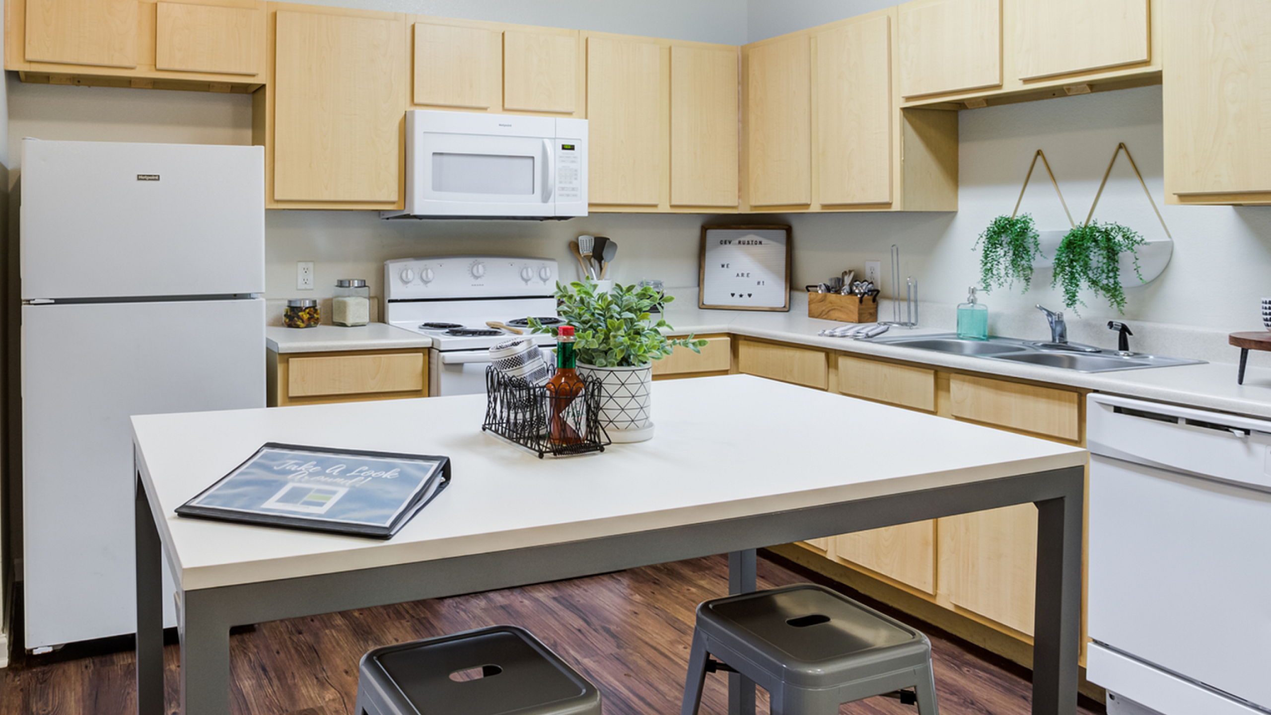 Modern kitchen with sleek wooden cabinets, stainless steel appliances, and a stylish island with seating, perfect for entertaining.