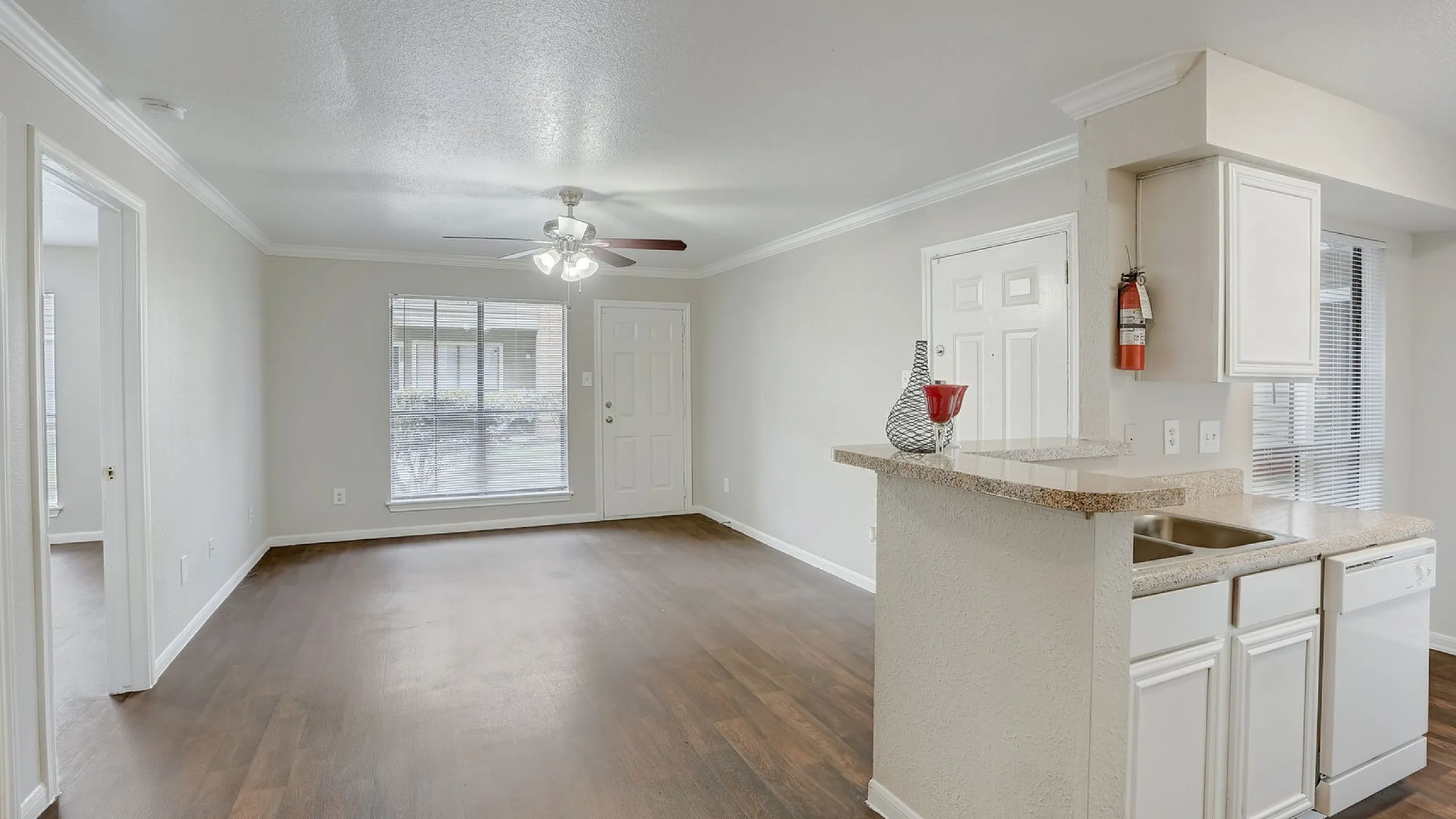 Bright, open-concept living space with elegant wood floors, modern kitchen, and ample natural light.