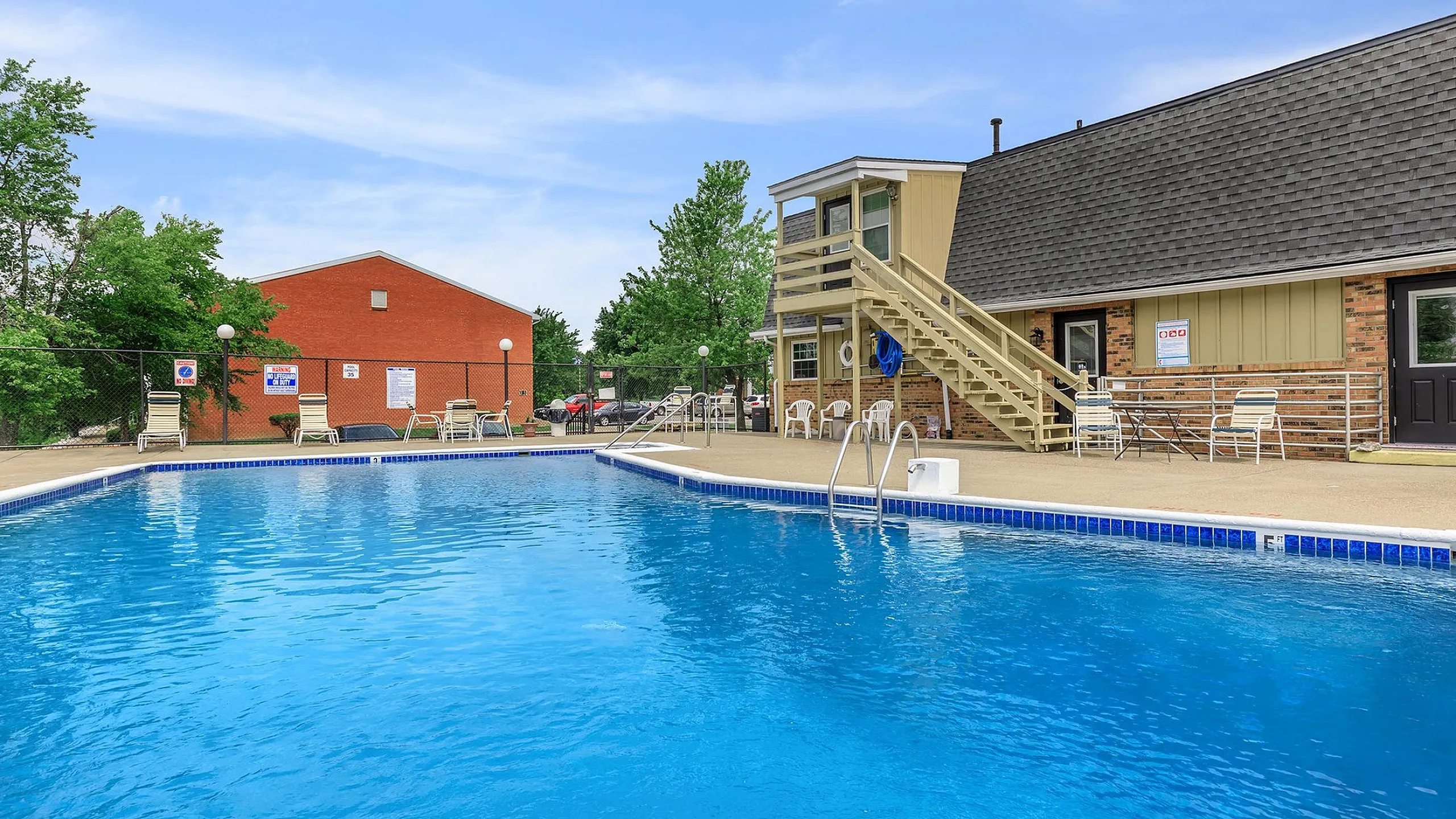 Inviting outdoor pool area with comfortable lounge chairs and modern facilities, perfect for relaxation and recreation.