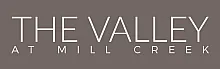 Elegant logo for The Valley at Mill Creek with sleek typography on a stylish gray background.