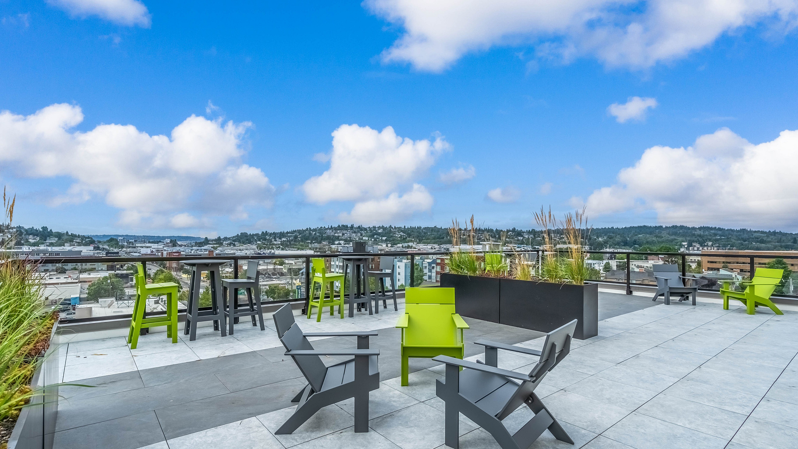 Chic rooftop terrace featuring modern seating and panoramic city views, perfect for relaxation and entertaining.