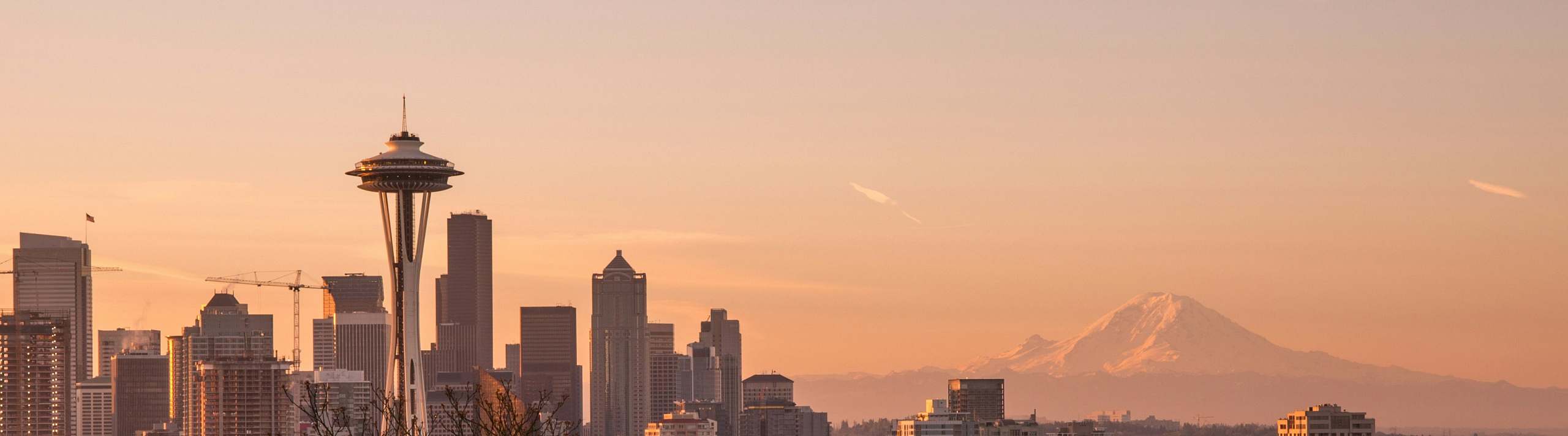 Stunning Seattle skyline at sunset showcasing iconic Space Needle with Mount Rainier in the background, perfect cityscape view.