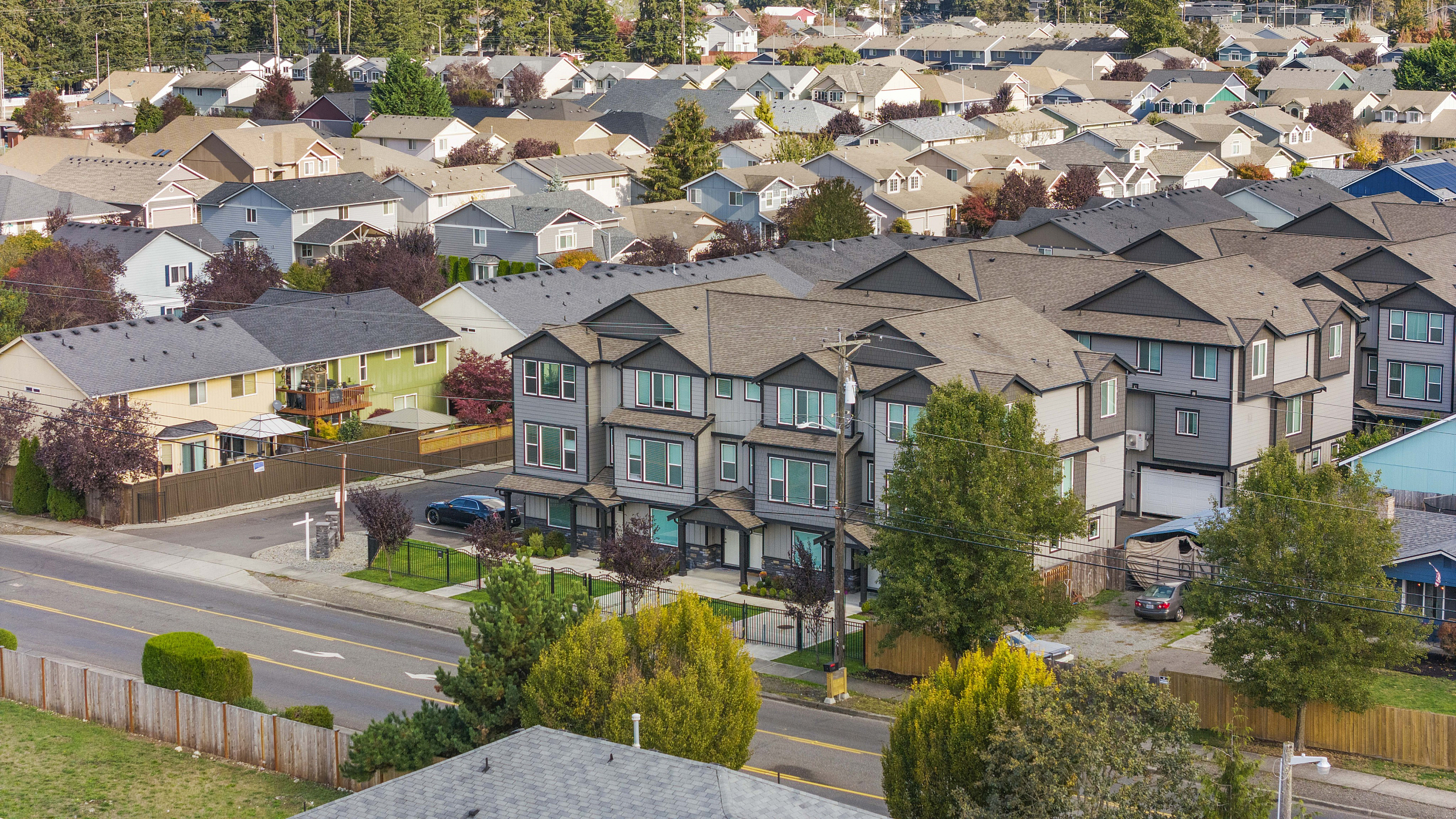 Charming residential neighborhood with modern townhouses, tree-lined streets, and a vibrant community atmosphere.