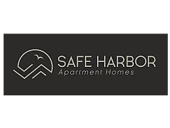 Elegant logo of Safe Harbor Apartment Homes with a minimalist design featuring a stylized bird and mountain graphic.