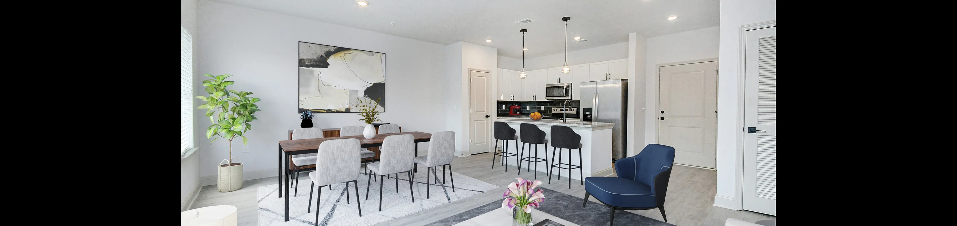 Modern open-concept living space with sleek kitchen, stylish dining area, and cozy seating arrangement.