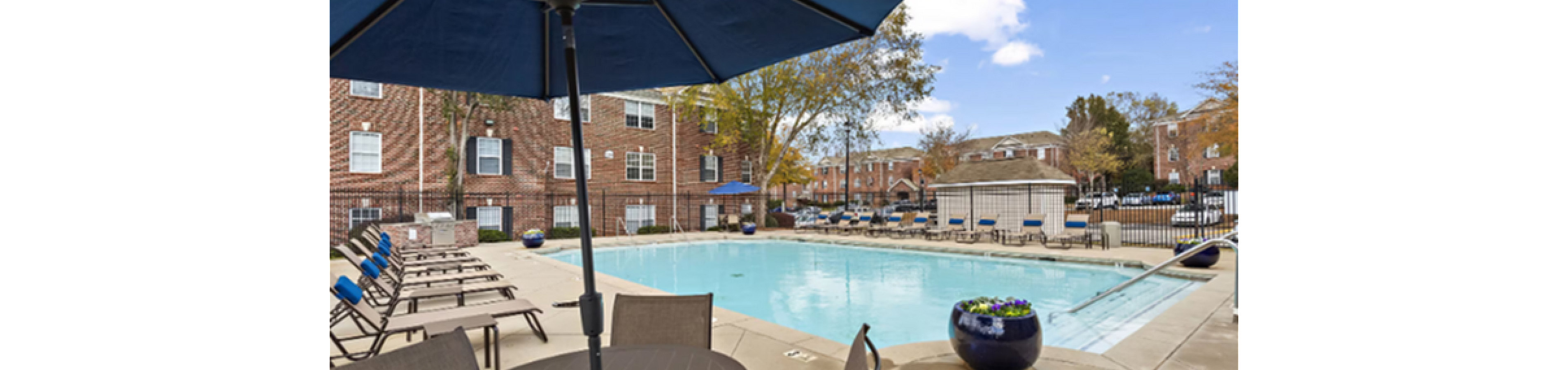 Inviting outdoor pool area with stylish patio furniture and vibrant potted plants, perfect for relaxation and social gatherings.