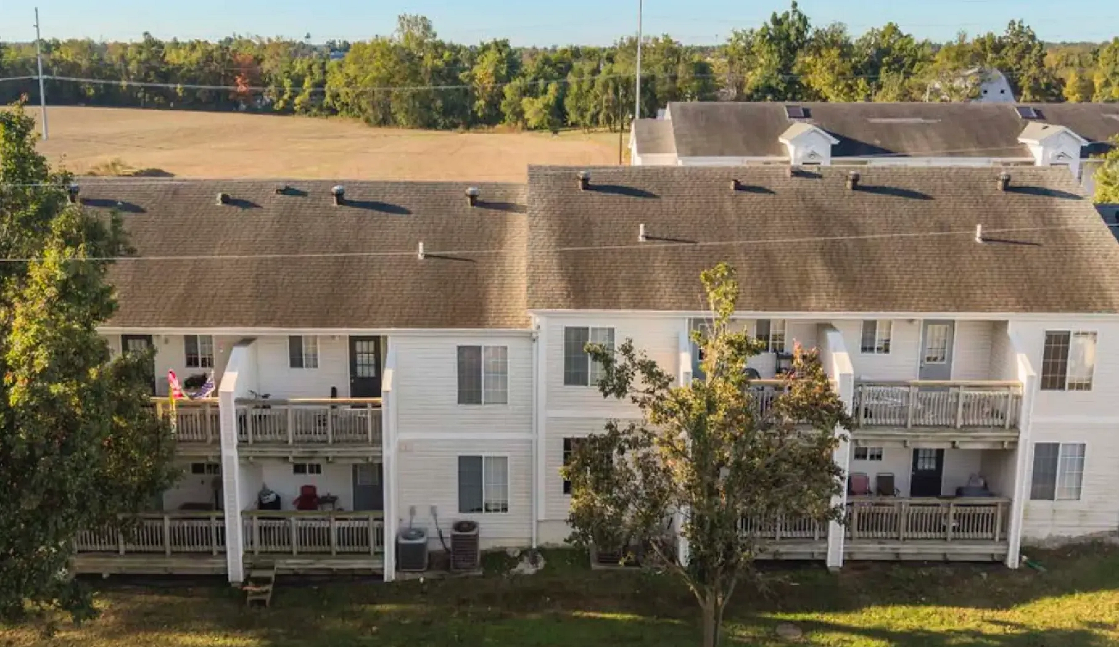 A drone image of the property, which shows the balconies and landscaping behind the building, along with the peaceful nature surrounding the property.