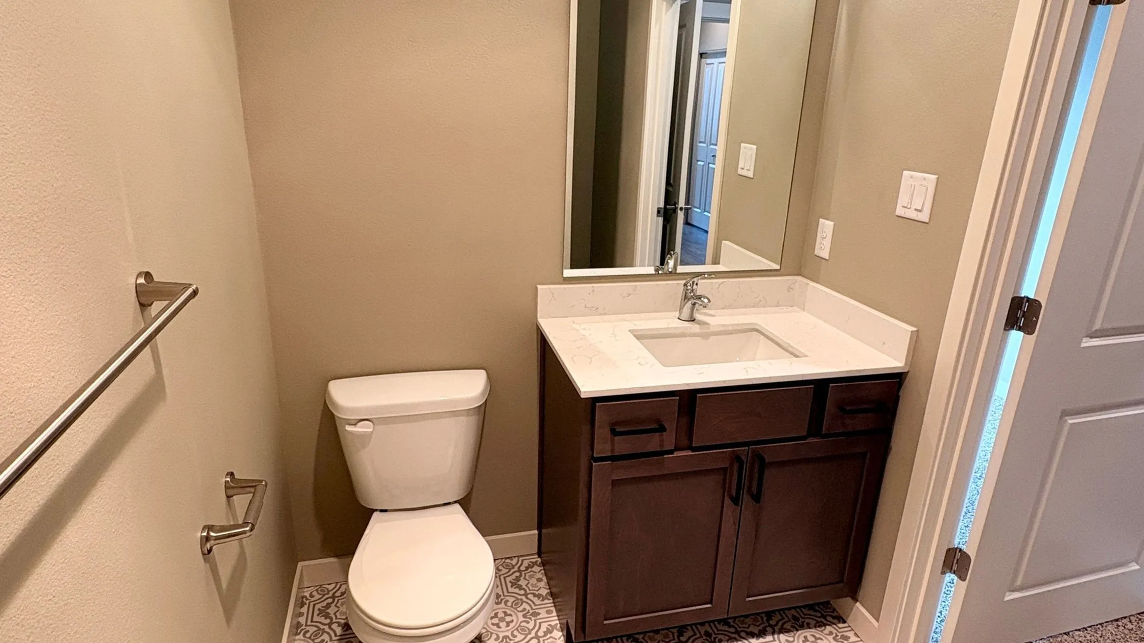 Modern bathroom with sleek vanity, elegant mirror, and contemporary design in neutral tones.