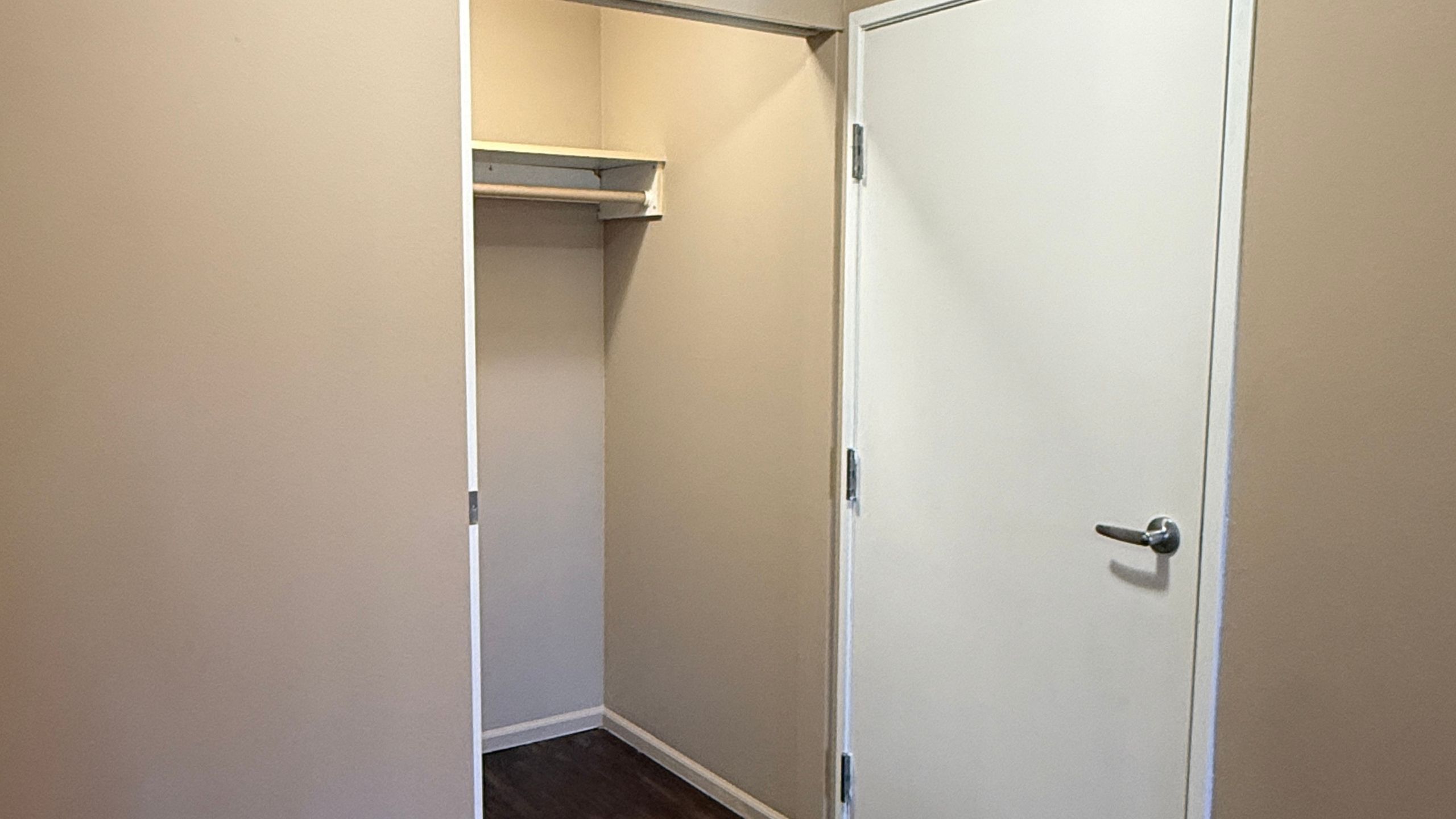 Elegant walk-in closet with ample space and sleek design in a modern apartment.