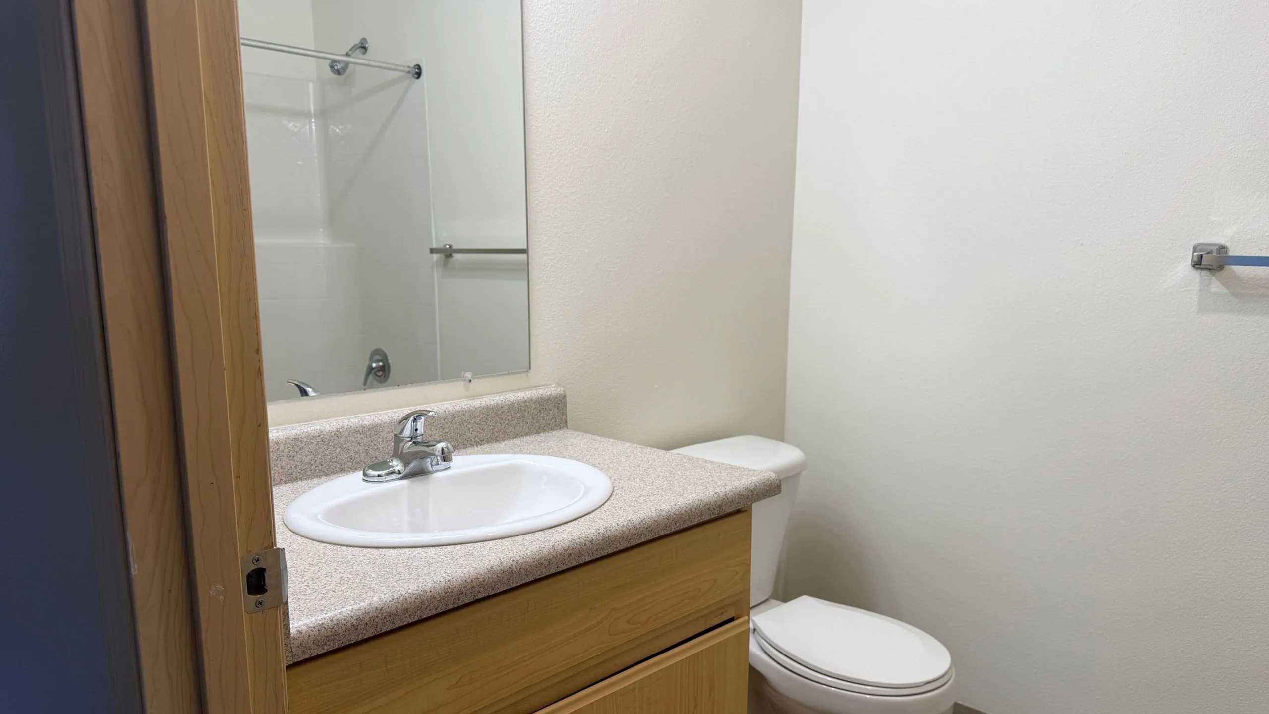 Modern bathroom featuring a sleek sink, elegant countertop, and a pristine white bathtub, offering a fresh and inviting atmosphere.