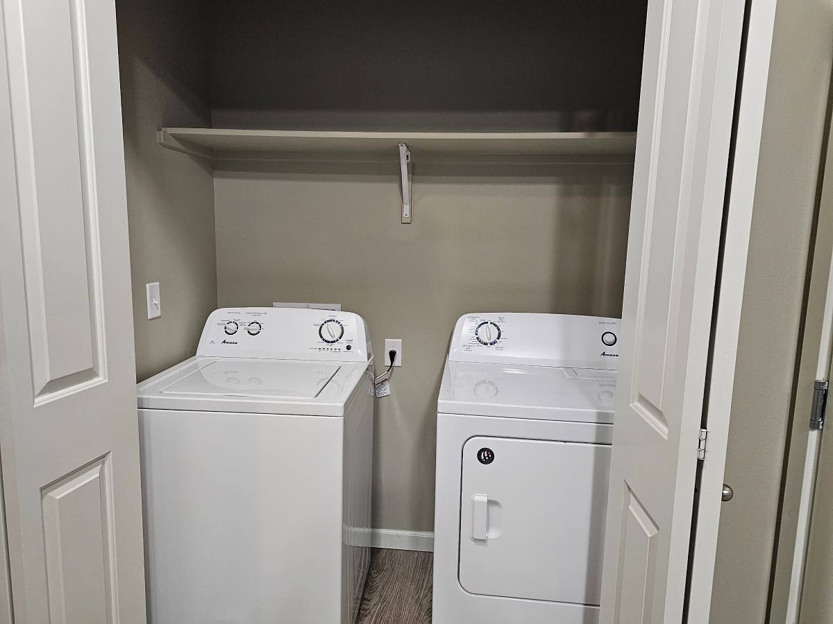 Modern laundry area with sleek washer and dryer in a convenient closet space.
