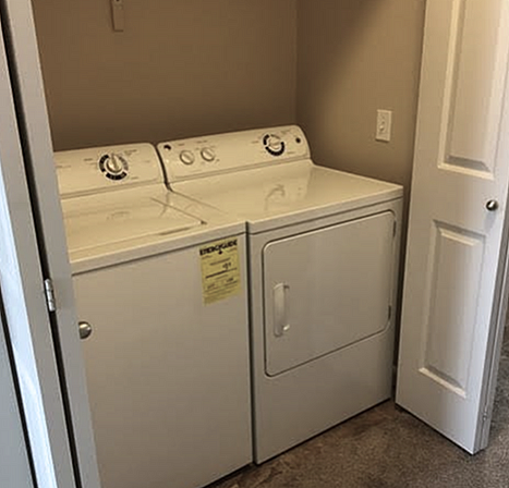 Convenient in-unit laundry with modern washer and dryer setup in a cozy alcove.