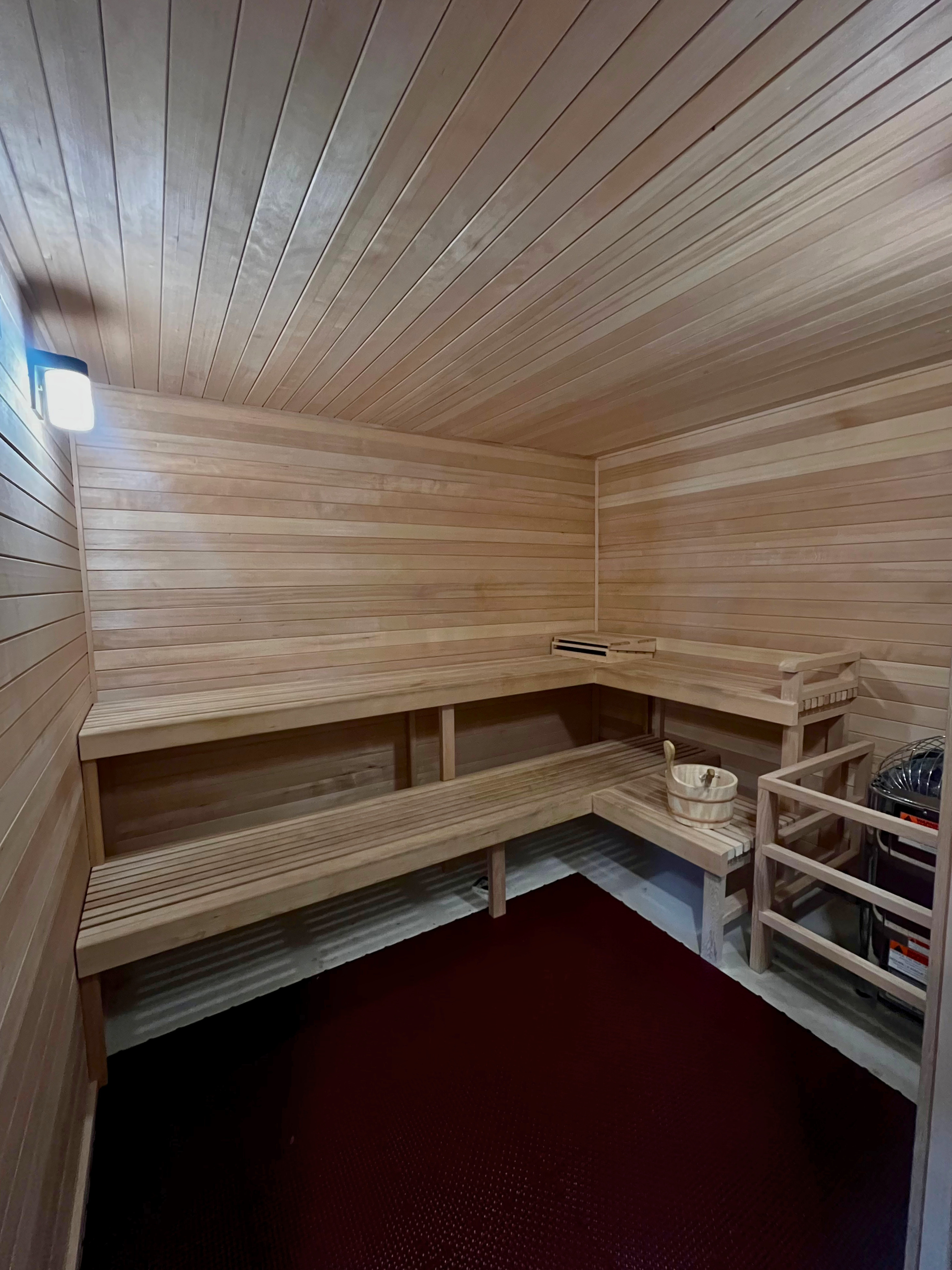 Luxurious wooden sauna room with elegant benches and a warm, inviting ambiance.