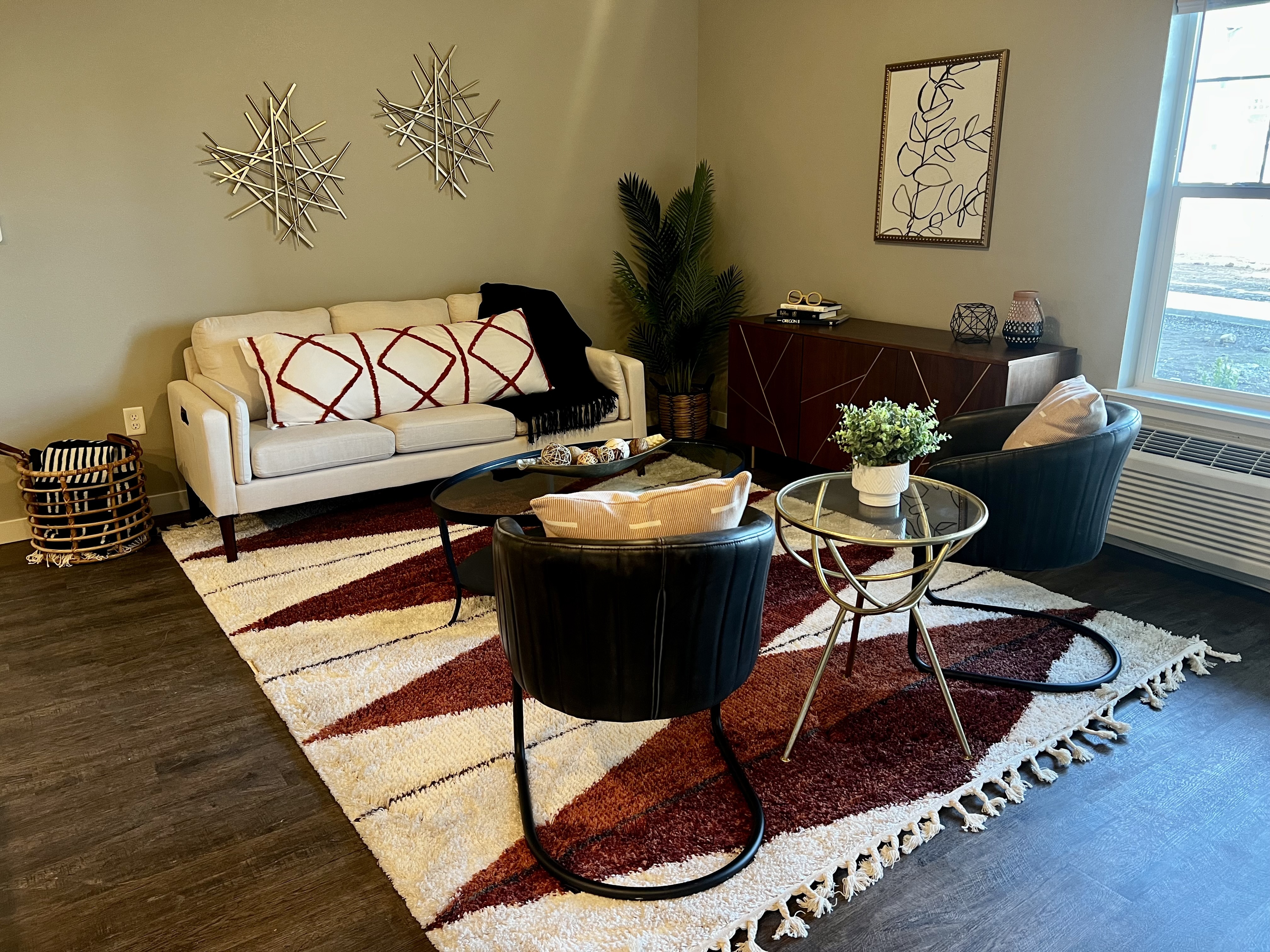 Elegant living room with cozy sofa, stylish chairs, and contemporary decor, perfect for relaxation and entertaining.