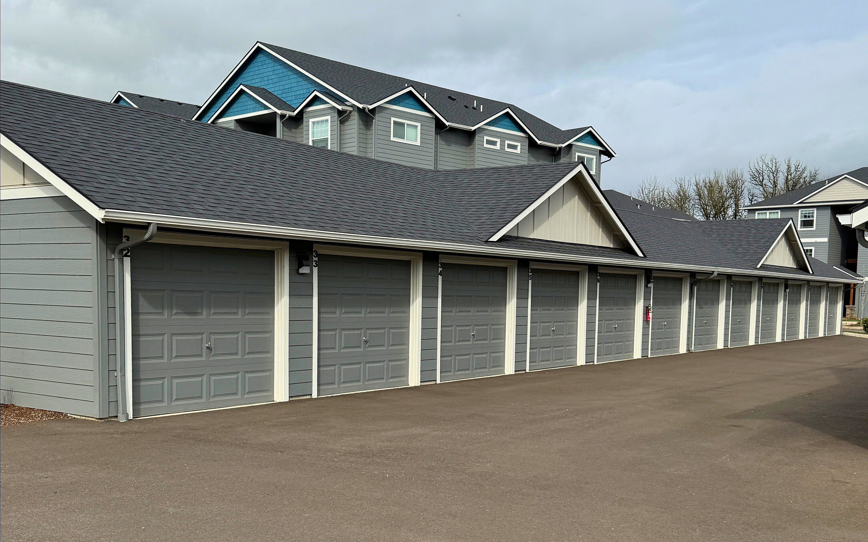 Inviting townhouse complex with charming multi-garage units and modern architectural design, set in a serene neighborhood.
