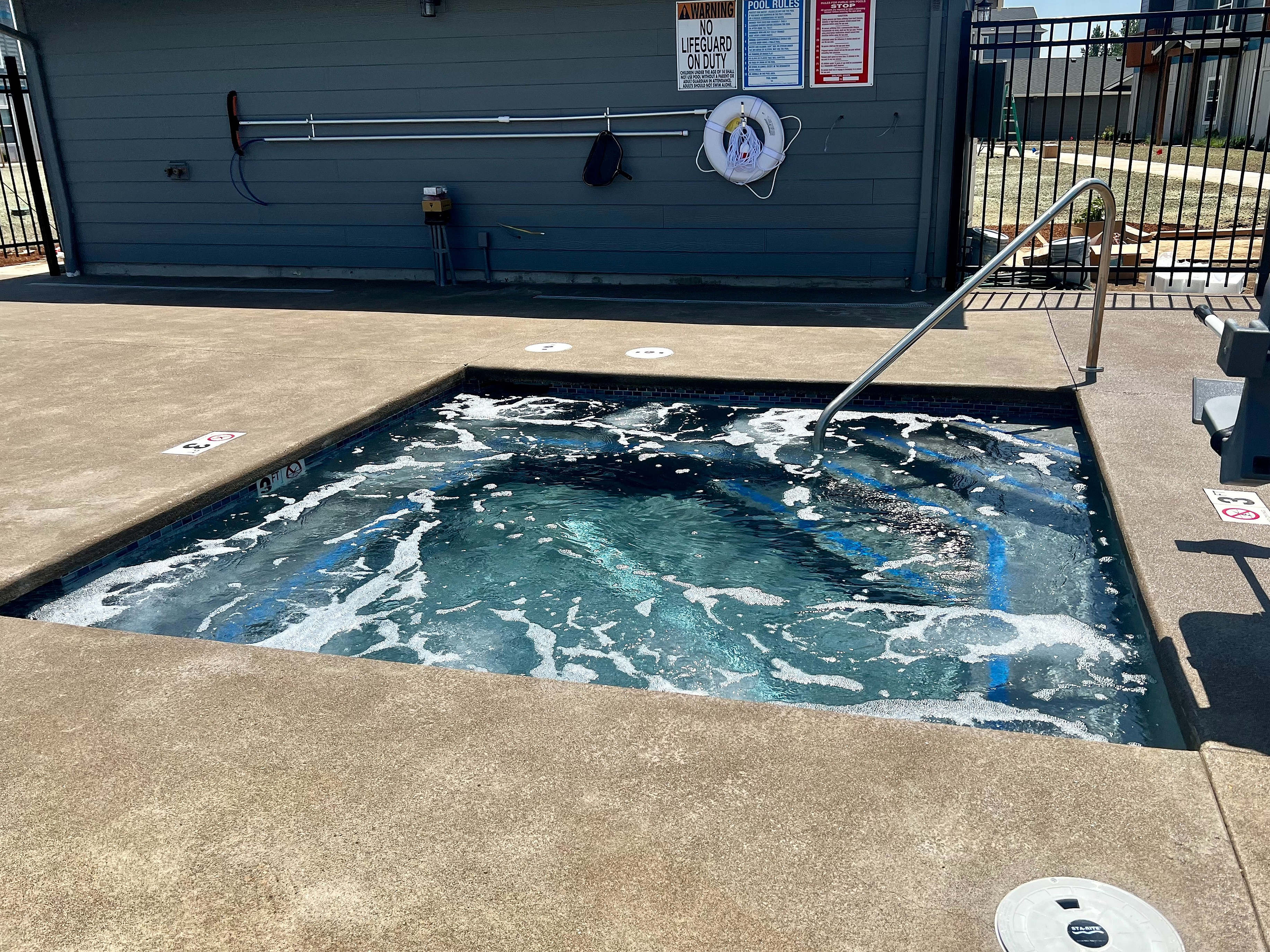 Inviting outdoor jacuzzi with bubbling water and modern safety features, perfect for relaxation.