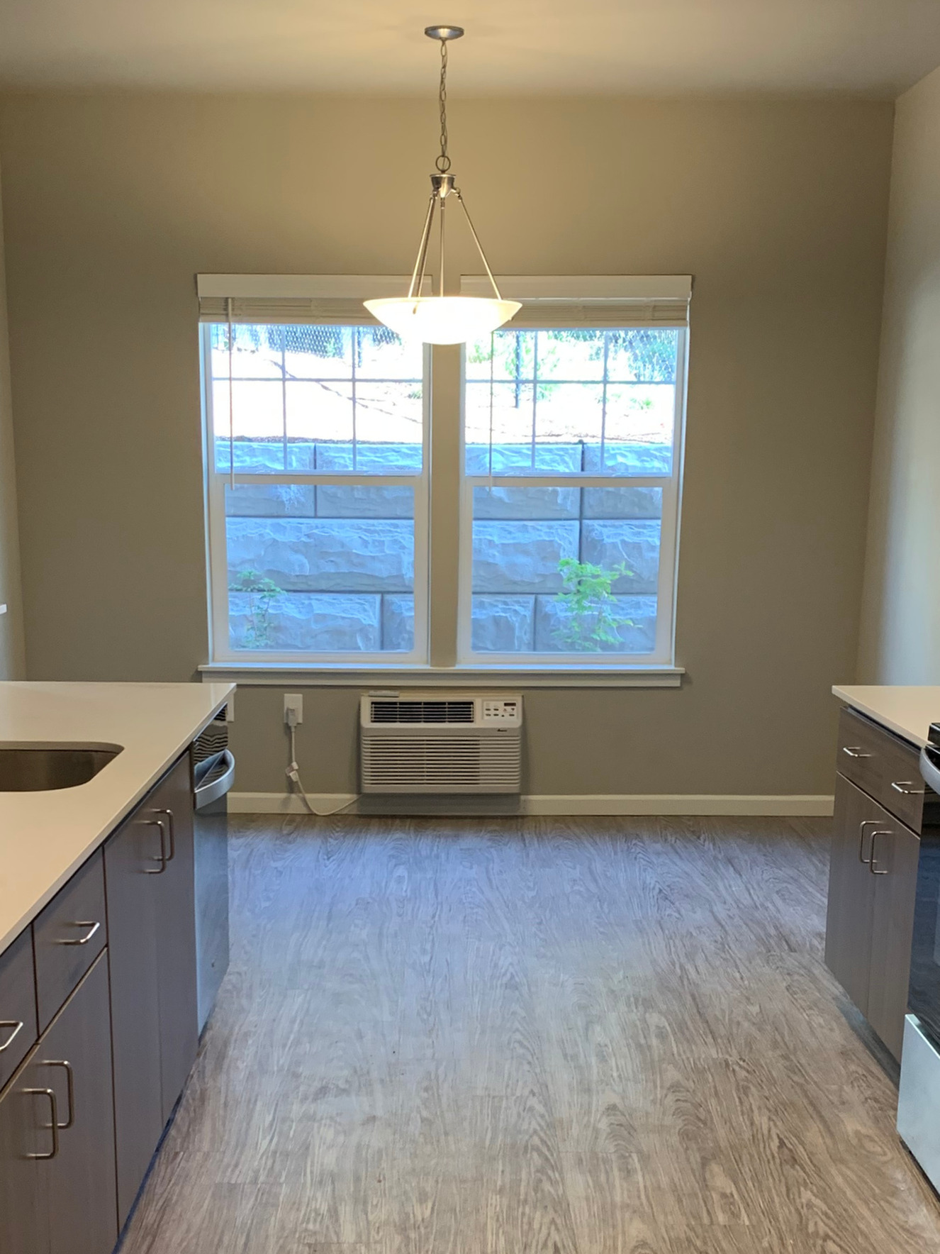 Bright and inviting kitchen space with modern cabinetry, sleek countertops, and a beautiful window view.