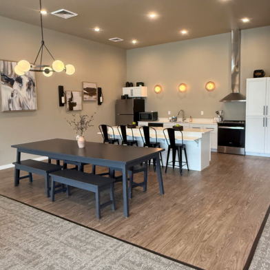 Chic open-concept kitchen and dining area featuring modern lighting, sleek furniture, and elegant decor.