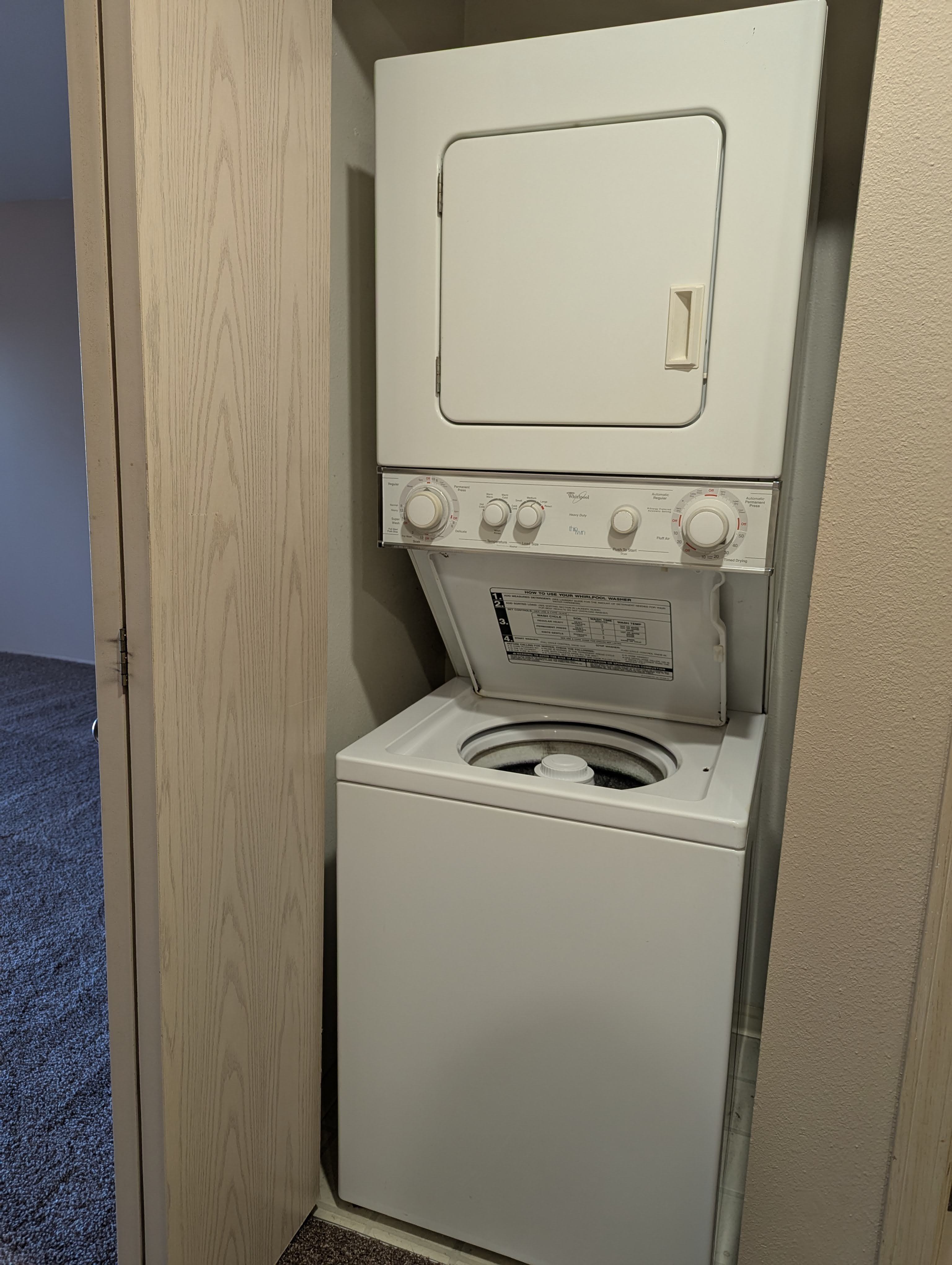 Convenient in-unit stacked washer and dryer set in a modern apartment interior.