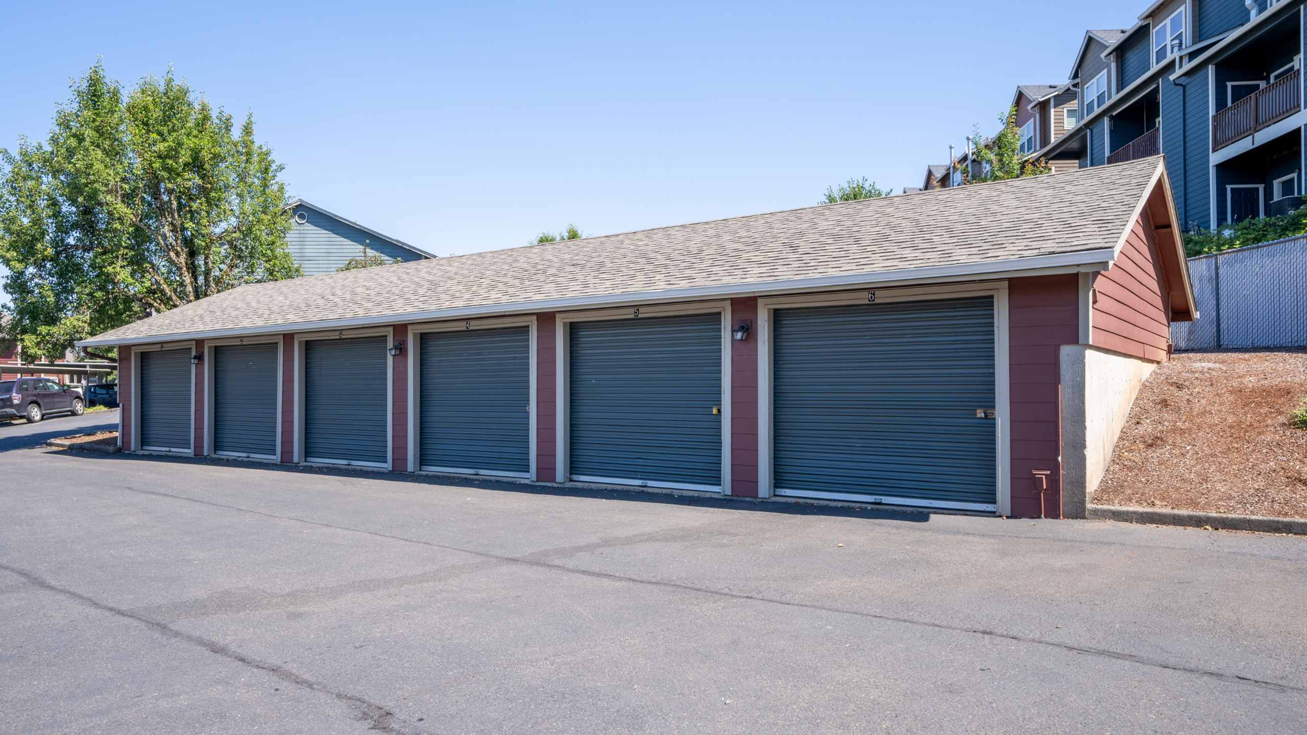 Spacious garage facility featuring multiple secure storage units with a well-maintained exterior.