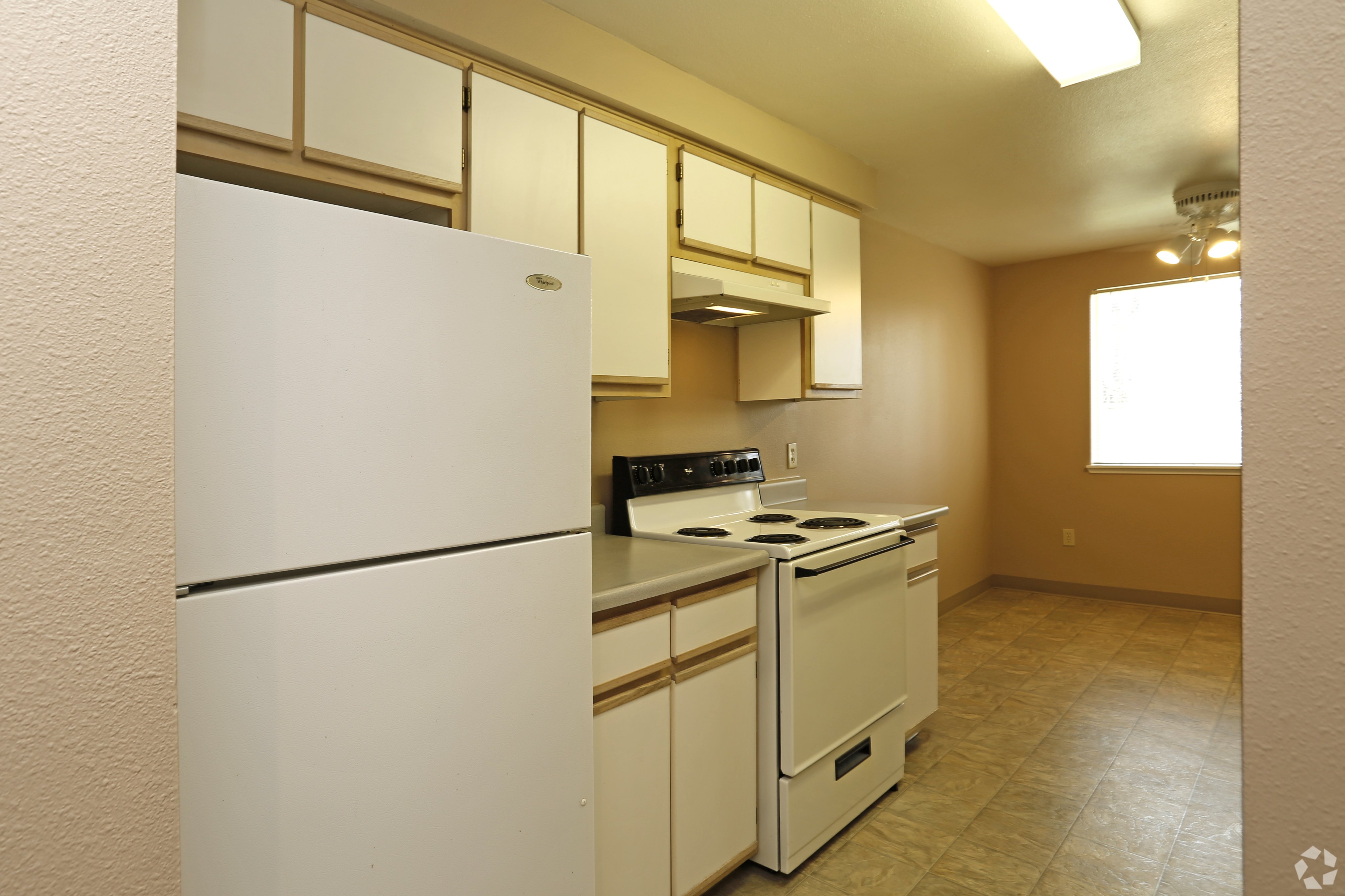 Bright and charming kitchen with modern appliances, ample cabinetry, and cozy breakfast area ideal for culinary creativity.