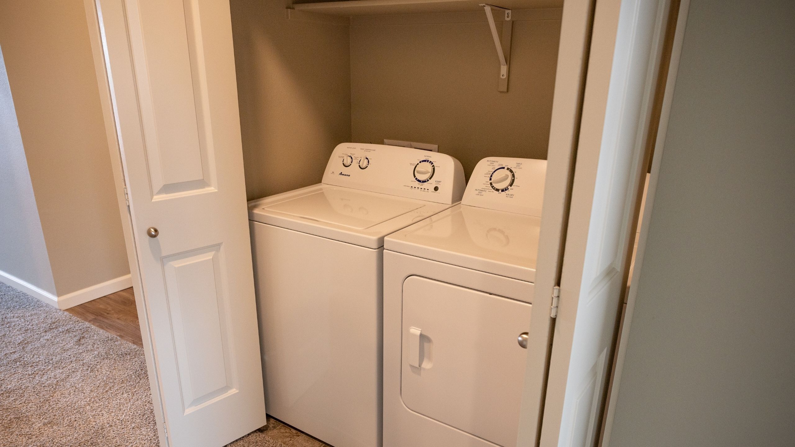 Convenient in-unit laundry area with washer and dryer, enhancing modern apartment living.